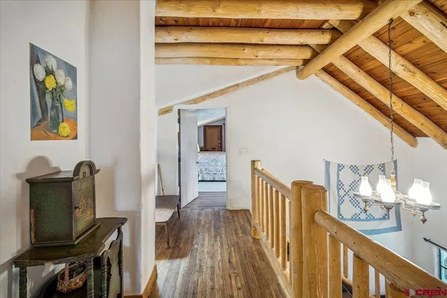 a hallway with wooden floor and furniture