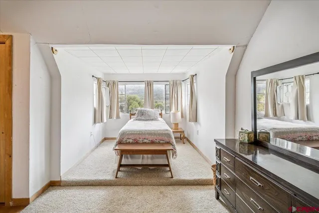 a living room with a patio table and a large window