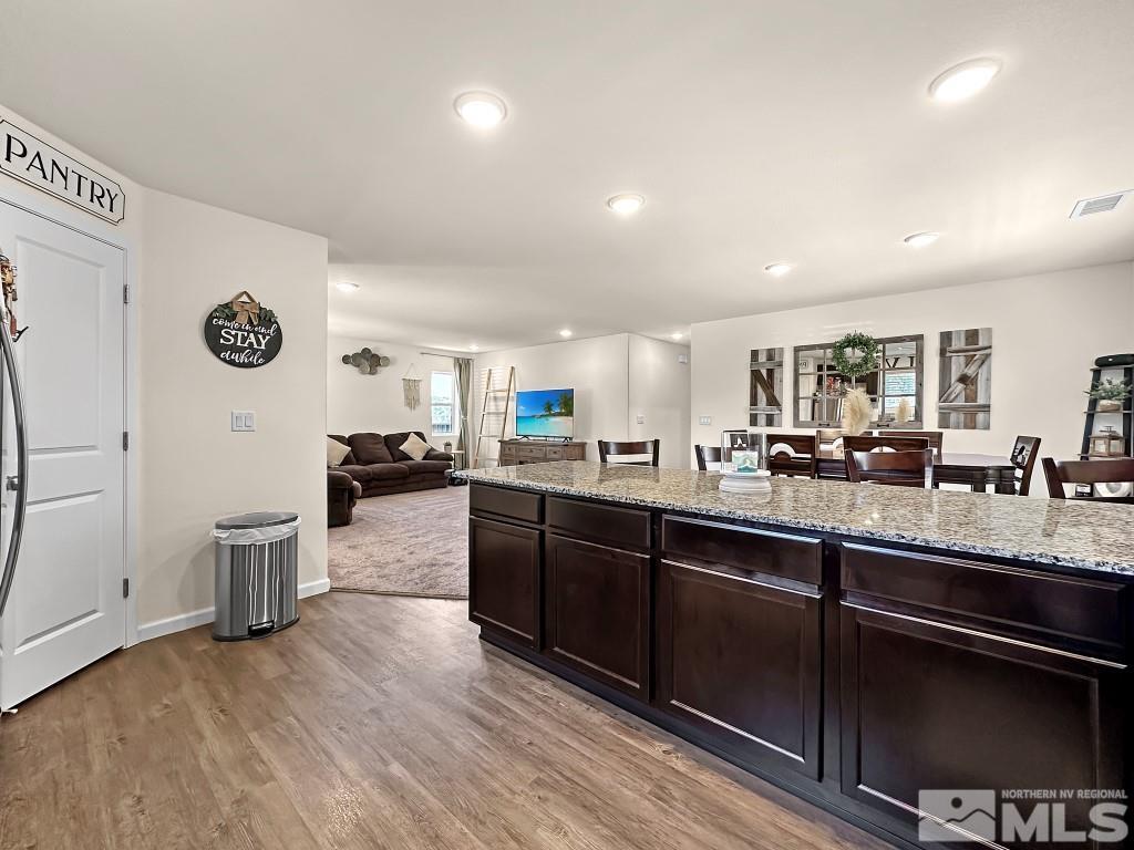 343 Double Spring Drive Reno, NV 89506 - Photo 12 of 27 a large kitchen with stainless steel appliances granite countertop a lot of counter space and wooden floor