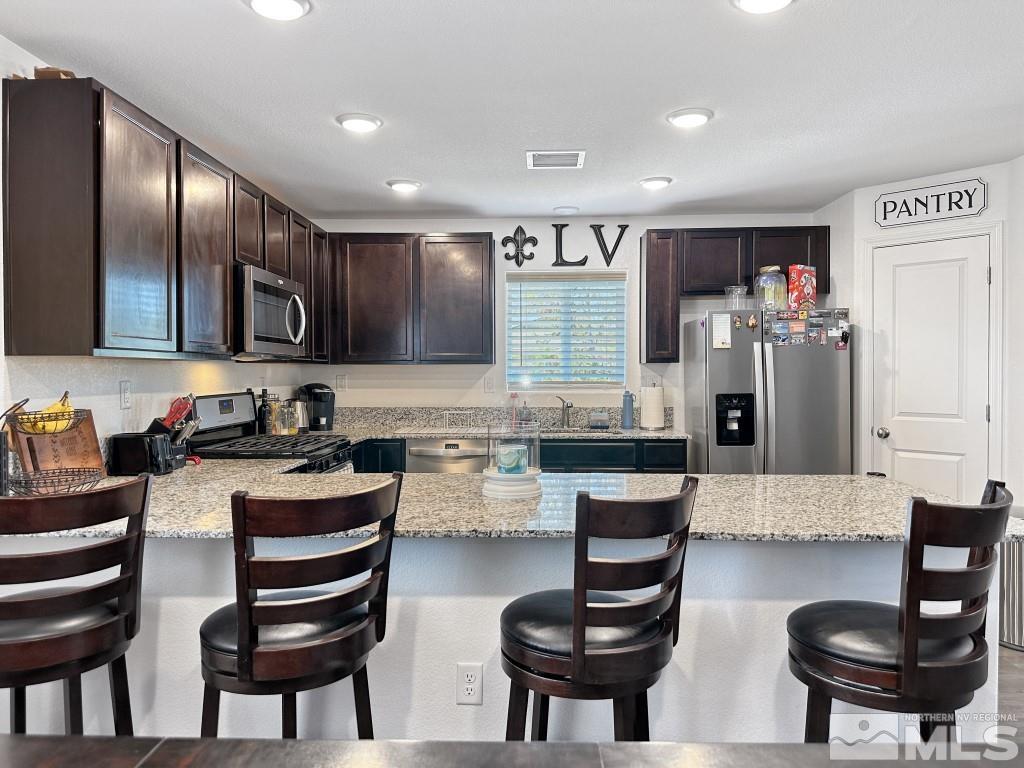 343 Double Spring Drive Reno, NV 89506 - Photo 13 of 27 a kitchen with granite countertop lots of counter top space