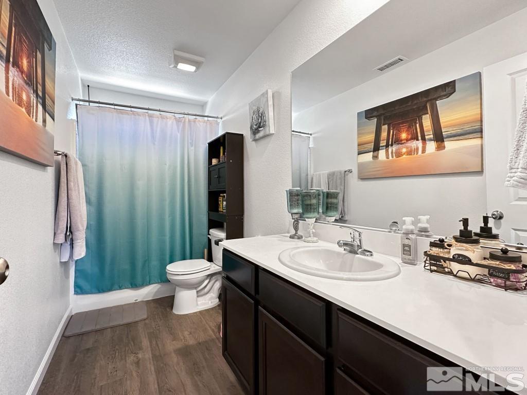 343 Double Spring Drive Reno, NV 89506 - Photo 16 of 27 a bathroom with a double vanity sink toilet and a shower