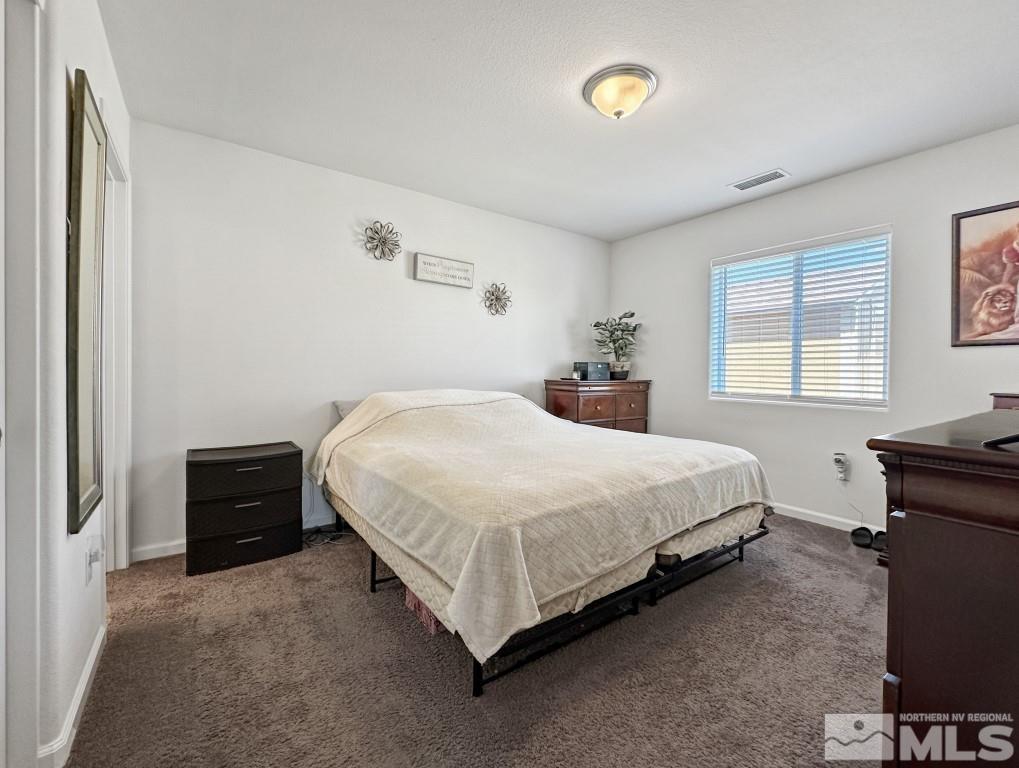 343 Double Spring Drive Reno, NV 89506 - Photo 17 of 27 a bedroom with a bed and a window