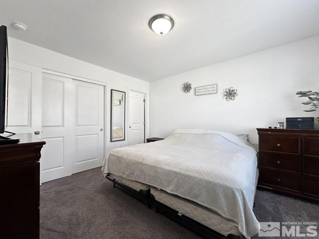 343 Double Spring Drive Reno, NV 89506 - Photo 18 of 27 a bedroom with a bed and a dresser