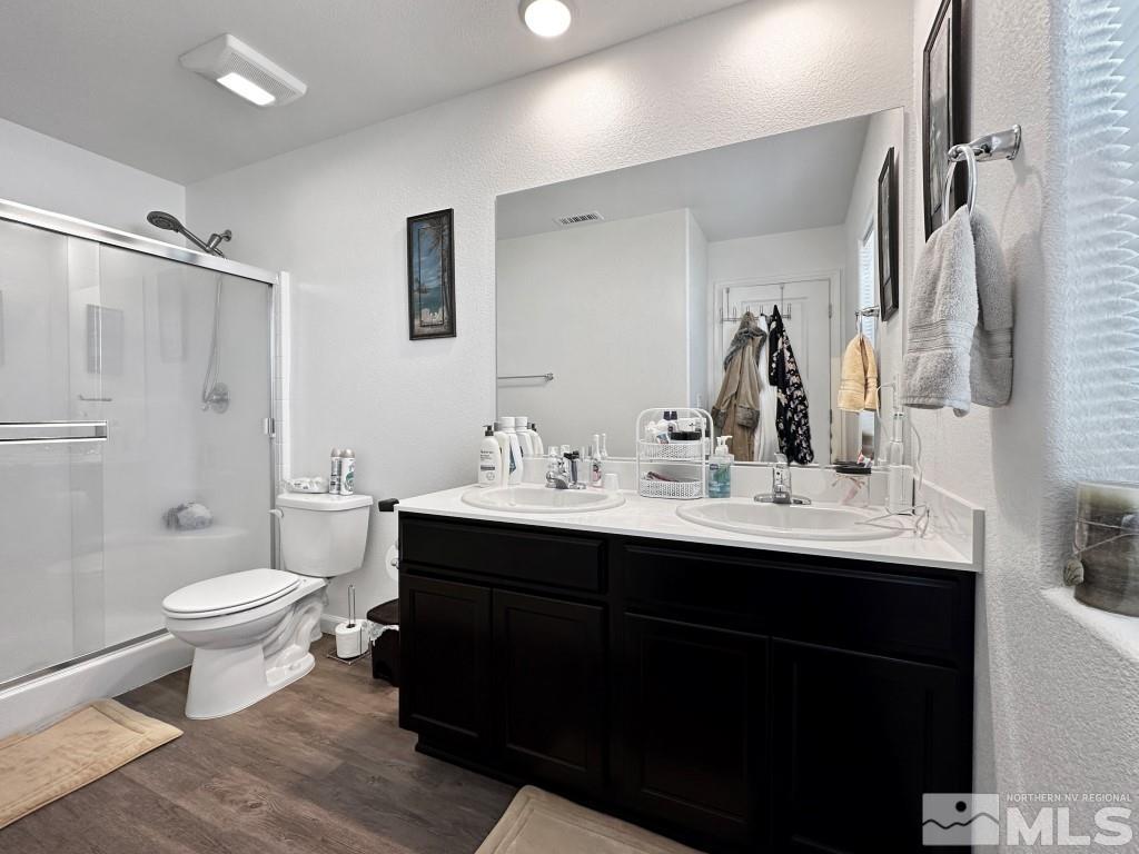 343 Double Spring Drive Reno, NV 89506 - Photo 19 of 27 a bathroom with a sink toilet a mirror and shower
