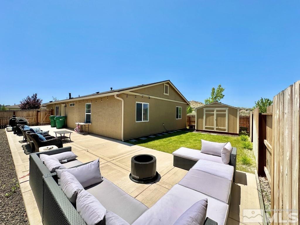 343 Double Spring Drive Reno, NV 89506 - Photo 25 of 27 a backyard of a house with fire pit and outdoor seating