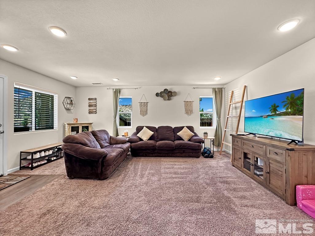 343 Double Spring Drive Reno, NV 89506 - Photo 7 of 27 a living room with furniture and a flat screen tv