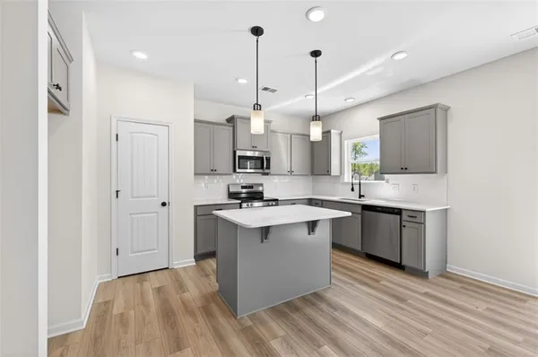 a kitchen with a table and chairs in it