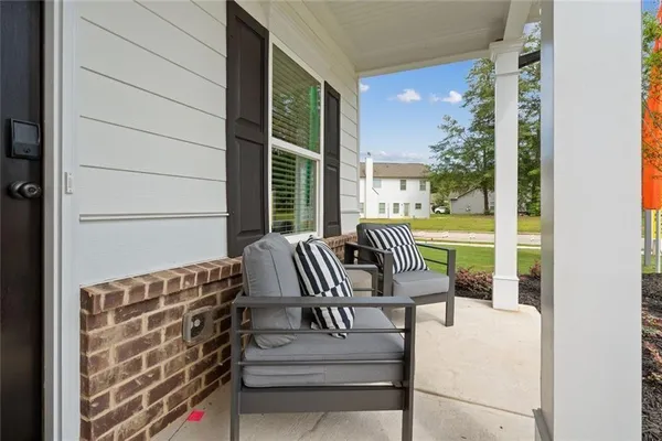 a balcony with furniture and a garden