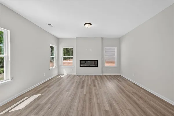 wooden floor in an empty room with a window