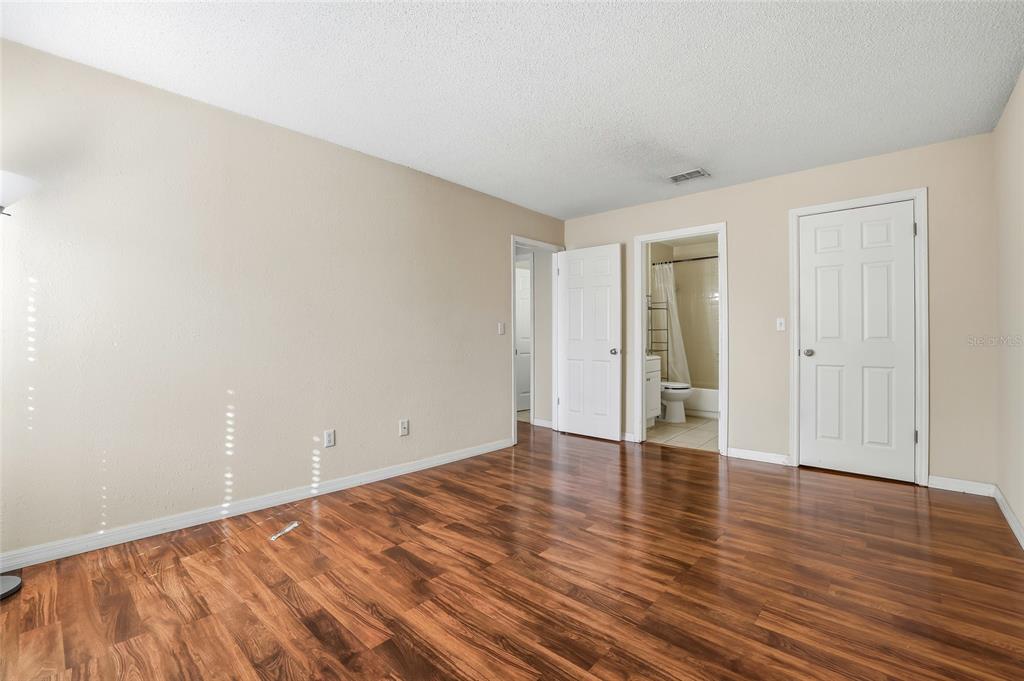 4004 Nestle Oaks Place, Unit 203 Tampa, FL 33613 - Photo 11 of 32 a view of an empty room with wooden floor and closet