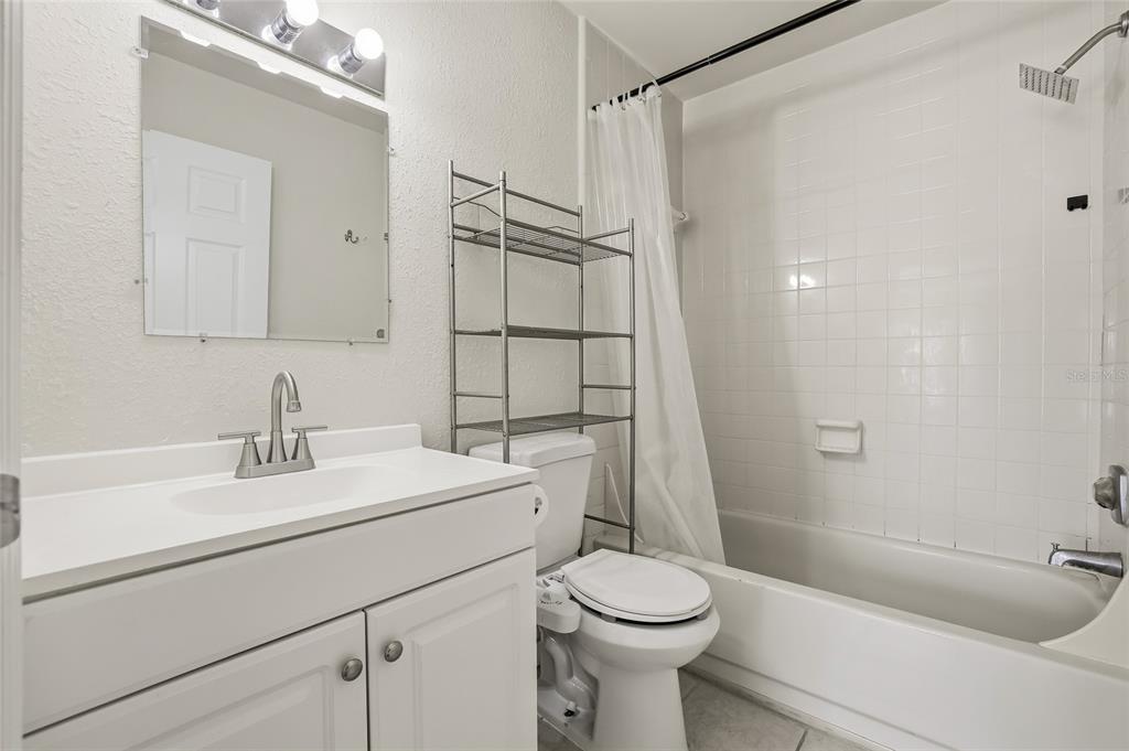 4004 Nestle Oaks Place, Unit 203 Tampa, FL 33613 - Photo 12 of 32 a bathroom with a sink a toilet and shower