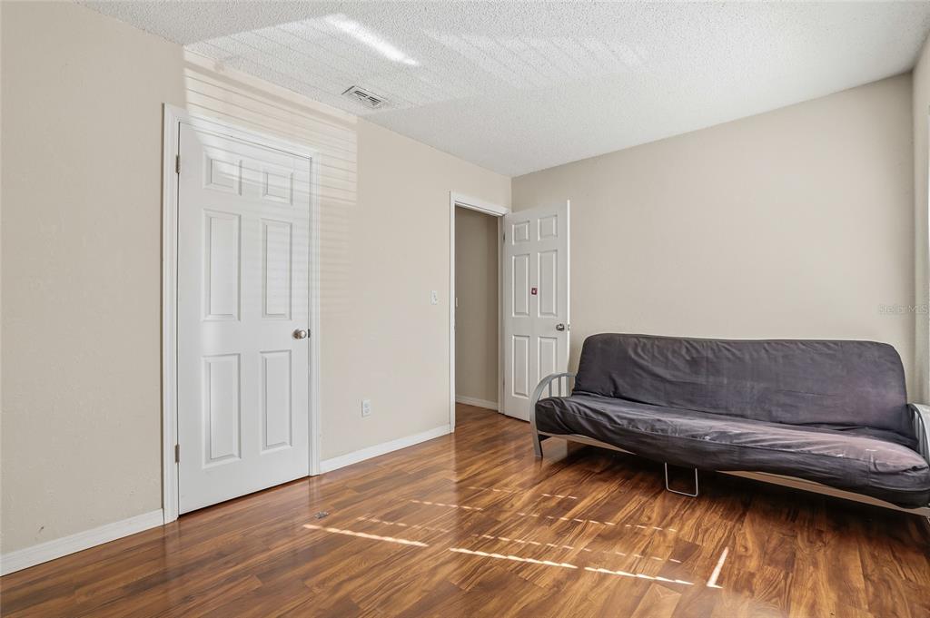 4004 Nestle Oaks Place, Unit 203 Tampa, FL 33613 - Photo 13 of 32 a living room with a couch and a wooden floor
