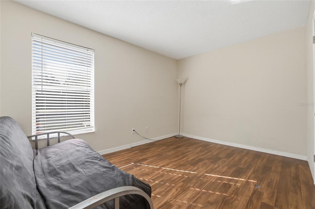 4004 Nestle Oaks Place, Unit 203 Tampa, FL 33613 - Photo 14 of 32 a bedroom with a bed and a window