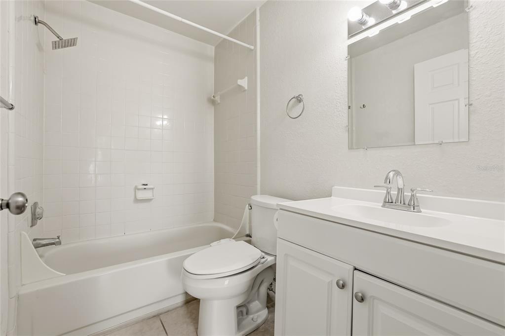 4004 Nestle Oaks Place, Unit 203 Tampa, FL 33613 - Photo 16 of 32 a bathroom with a sink a toilet and shower