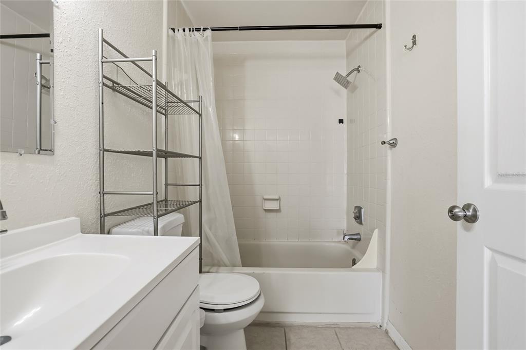 4004 Nestle Oaks Place, Unit 203 Tampa, FL 33613 - Photo 17 of 32 a bathroom with a sink a toilet and shower