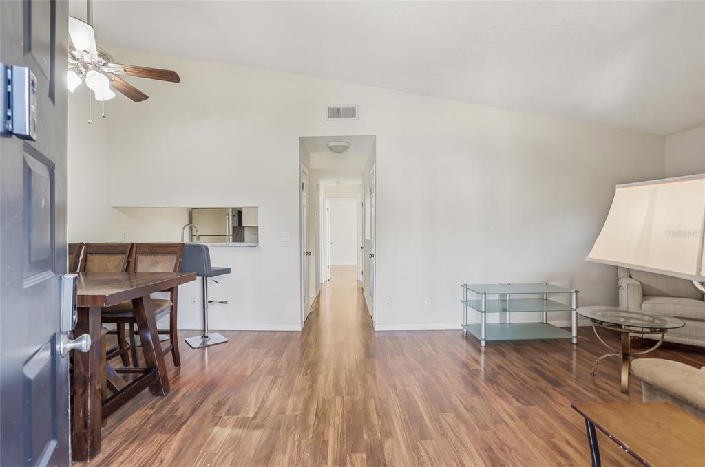 4004 Nestle Oaks Place, Unit 203 Tampa, FL 33613 - Photo 18 of 32 a view of a dining room with furniture and wooden floor