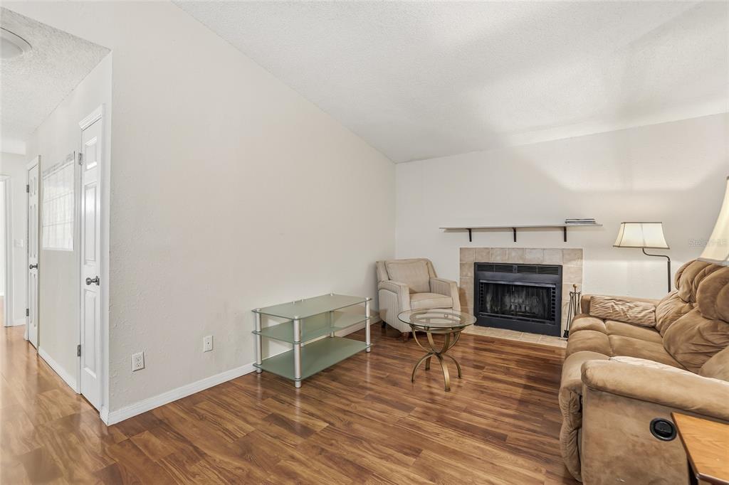 4004 Nestle Oaks Place, Unit 203 Tampa, FL 33613 - Photo 4 of 32 a living room with furniture and a fireplace
