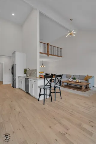 a view of a kitchen with furniture and wooden floor