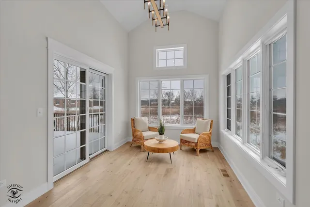 a living room with furniture and a floor to ceiling window