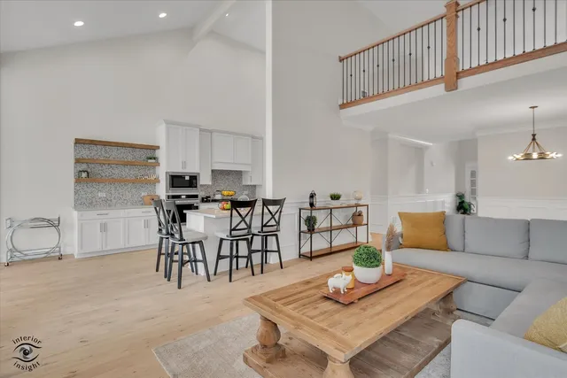 a living room with furniture and kitchen view