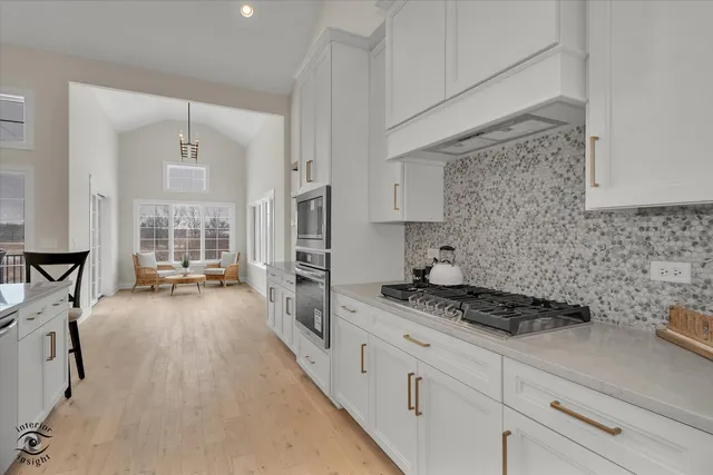 a kitchen with stainless steel appliances a stove a refrigerator and cabinets