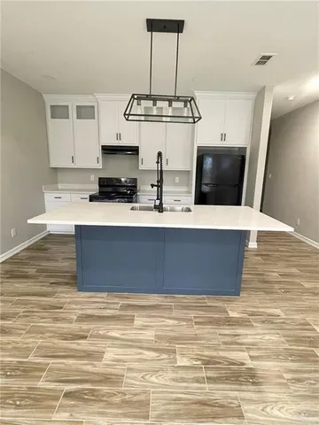 a view of kitchen island with cabinets