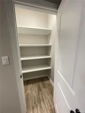 a view of walk in closet with empty racks