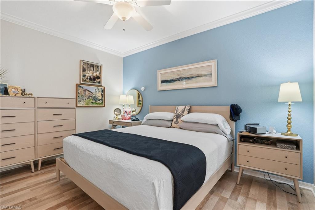 9715 Acqua Court, Unit 113 Naples, FL 34113 - Photo 15 of 31 Bedroom with ornamental molding, light wood finished floors, and ceiling fan