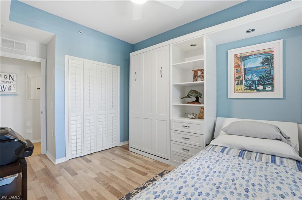 9715 Acqua Court, Unit 113 Naples, FL 34113 - Photo 18 of 31 Bedroom with a closet and light wood-style floors