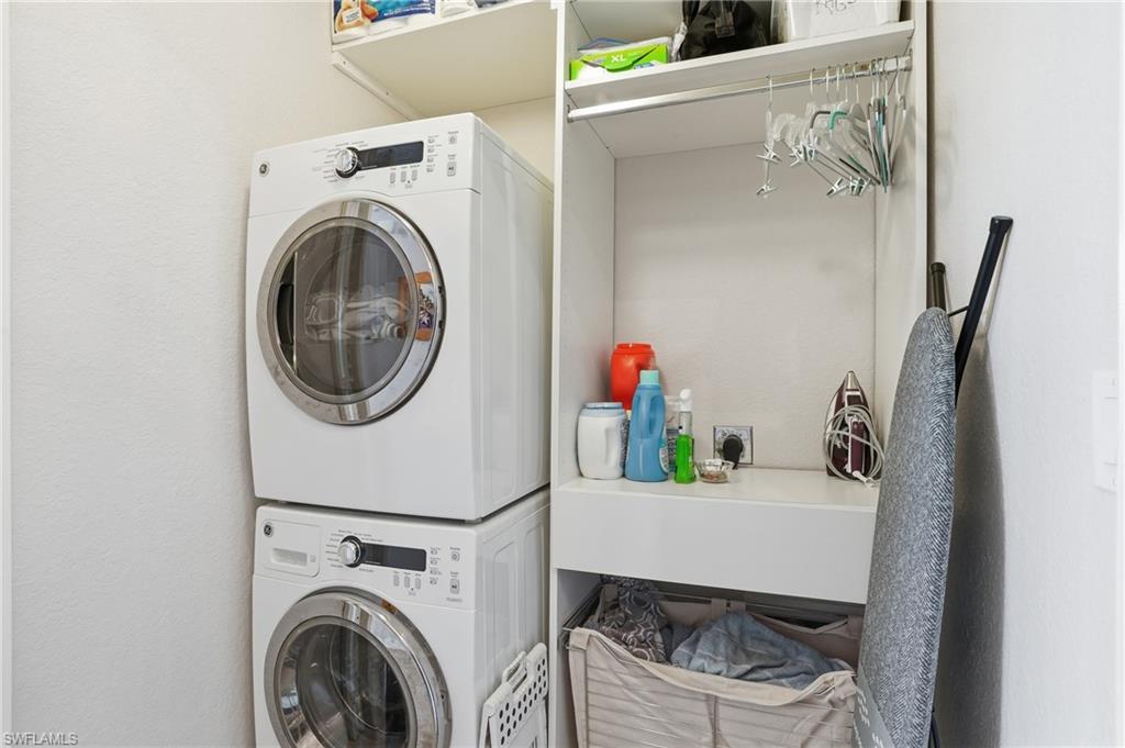 9715 Acqua Court, Unit 113 Naples, FL 34113 - Photo 20 of 31 Laundry room featuring stacked washer / drying machine