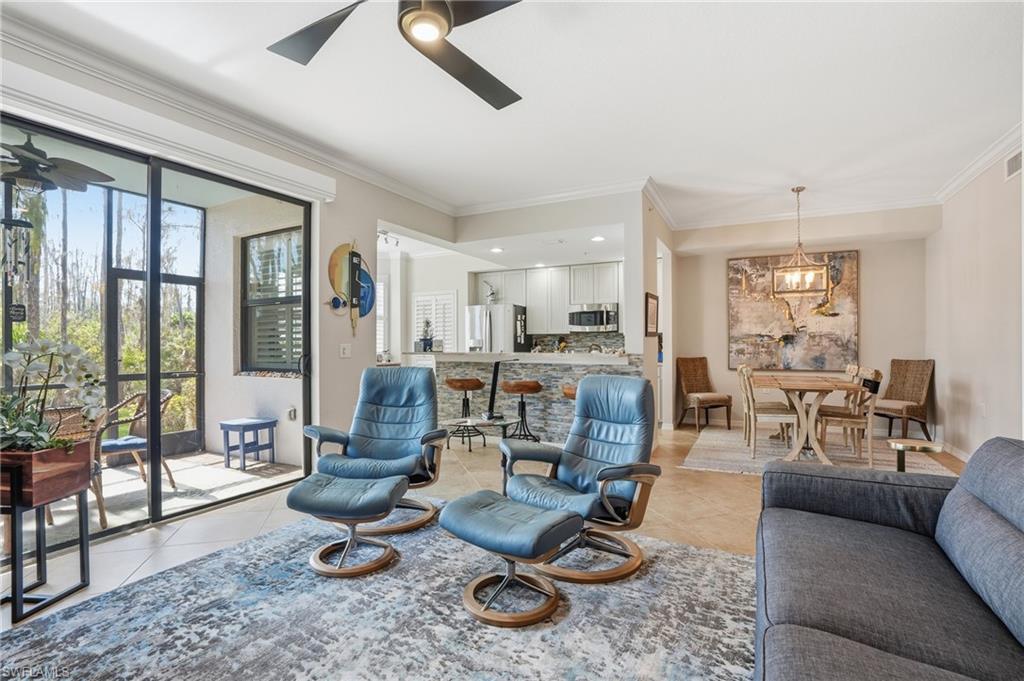 9715 Acqua Court, Unit 113 Naples, FL 34113 - Photo 10 of 31 Living area with ornamental molding, a ceiling fan, and light tile patterned floors