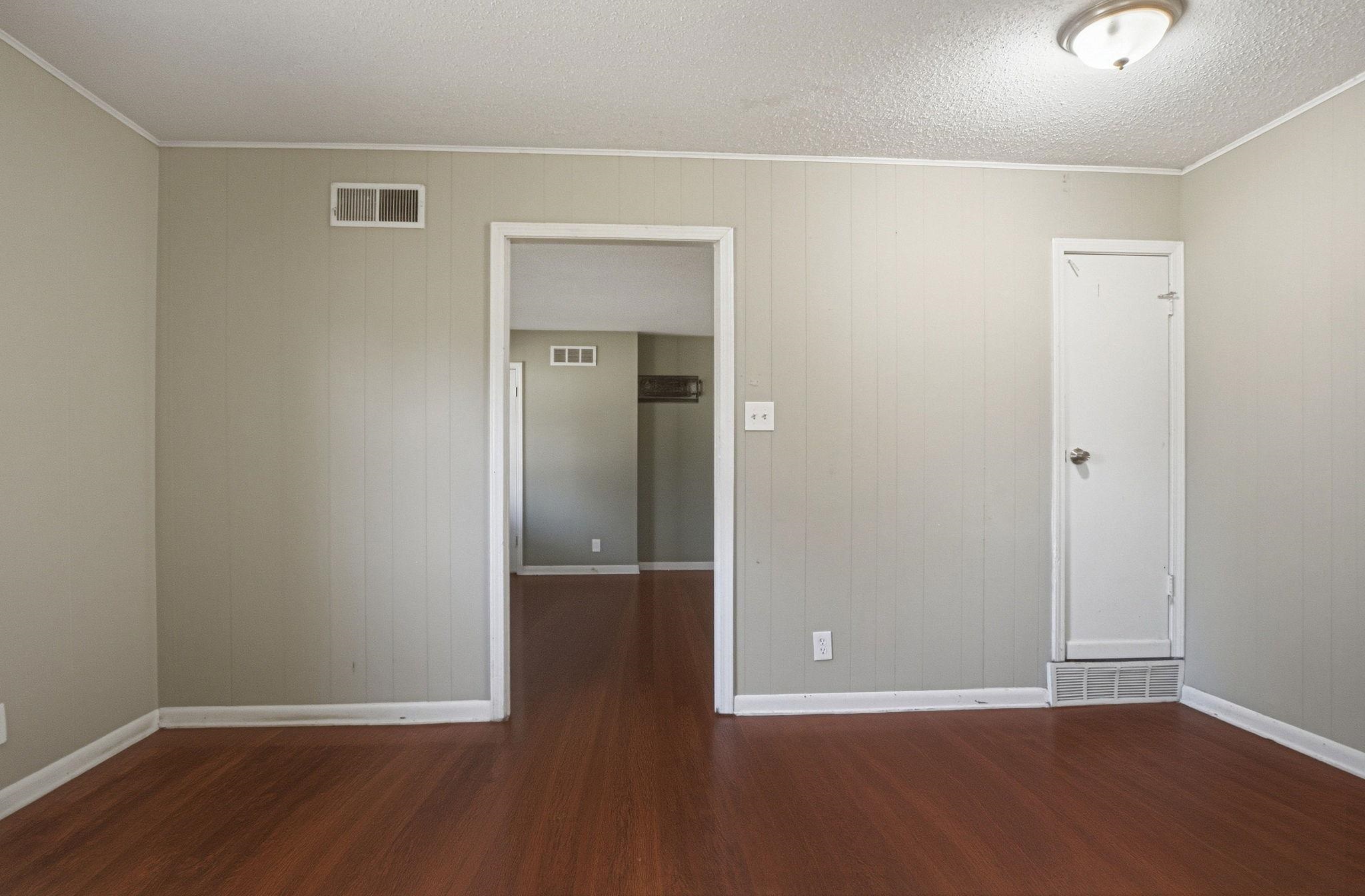 4562 Tulane Road Memphis, TN 38109 - Photo 12 of 32 Wood-finish flooring throughout, with a neutral wall color and white trim