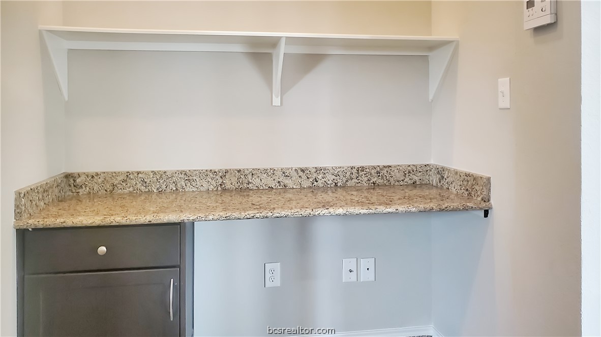 3741 Mariposa Court Bryan, TX 77808 - Photo 7 of 11 a bathroom with a granite countertop sink and vanity
