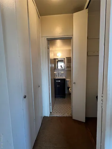 a view of a hallway to filled with rooms and furniture