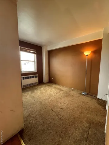 a view of a hallway and a livingroom with a bathroom