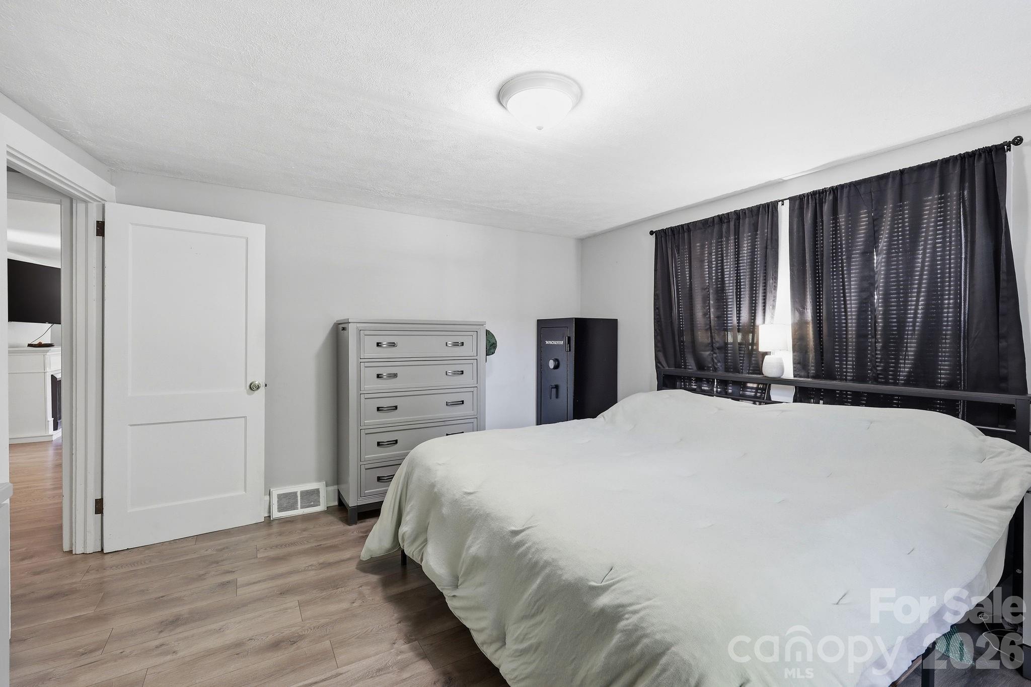 197 Mulberry Street Clyde, NC 28721 - Photo 13 of 31 a bed room with a bed and a television
