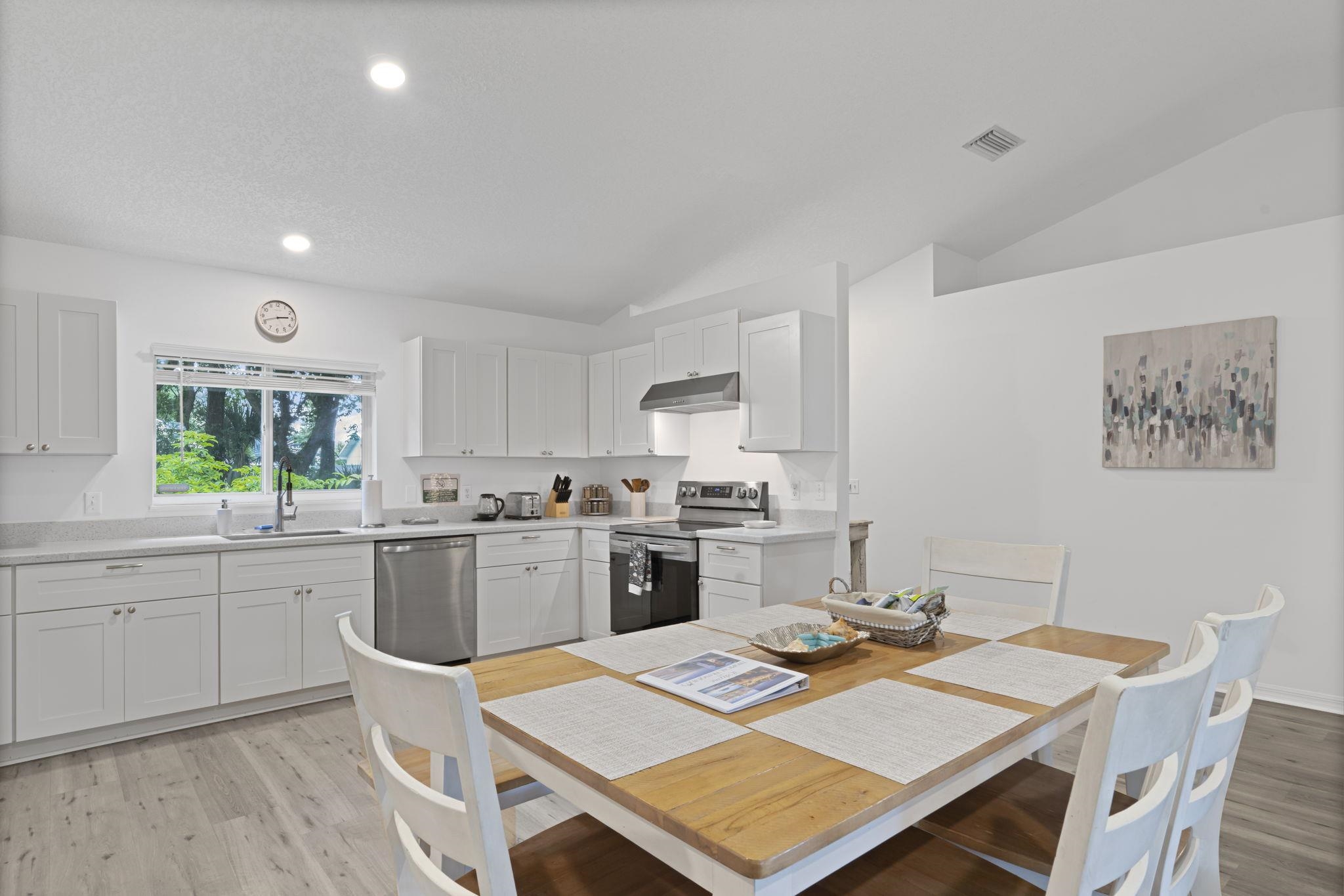 110 Dory Road St. Augustine, FL 32086 - Photo 10 of 35 a open dining room with a table chairs and kitchen view