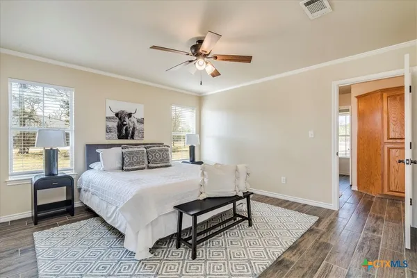 a bedroom with a bed and wooden floor