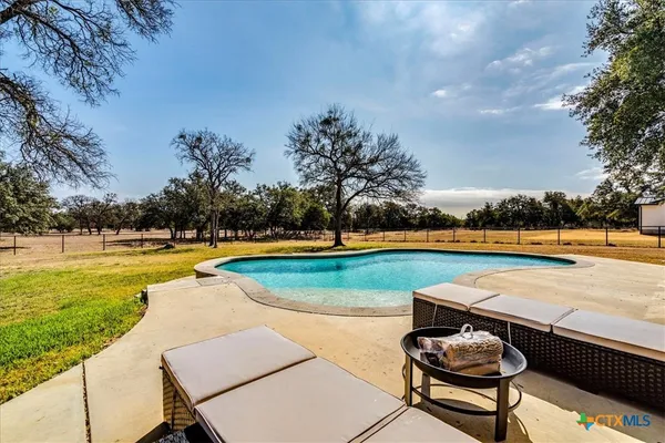 a view of a swimming pool with lounge chairs