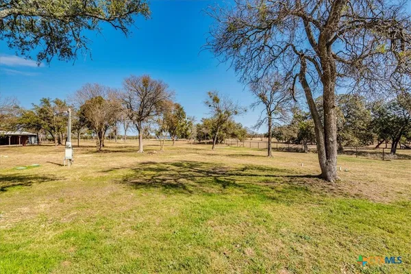 a view of lawn chairs and trees