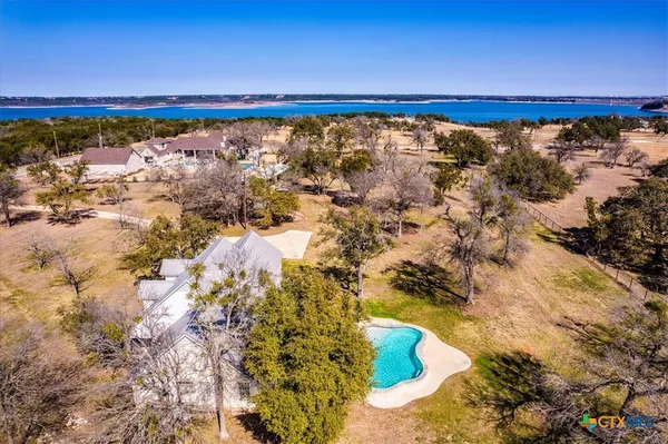 a view of a house with a yard covered in snow