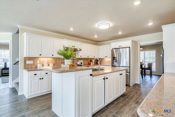 a kitchen with counter top space and sink