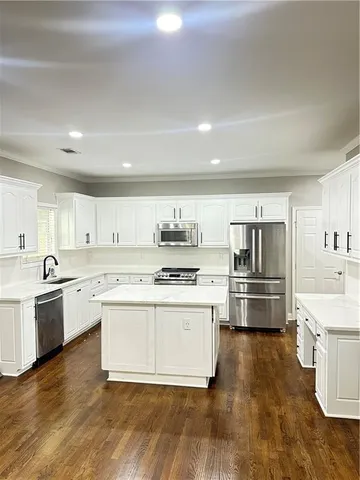 a kitchen with a stove top oven and refrigerator