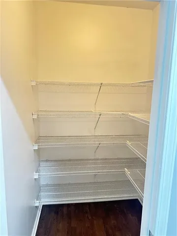 a view of walk in closet with empty racks