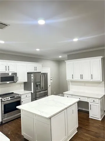 a kitchen with a stove a sink and a refrigerator