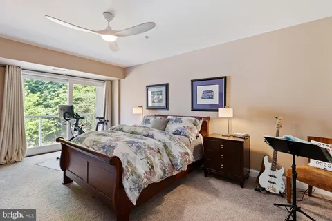a spacious bedroom with a bed and a large window