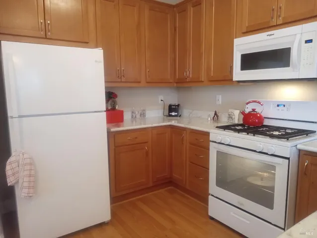 a view of a table and chairs under an umbrella