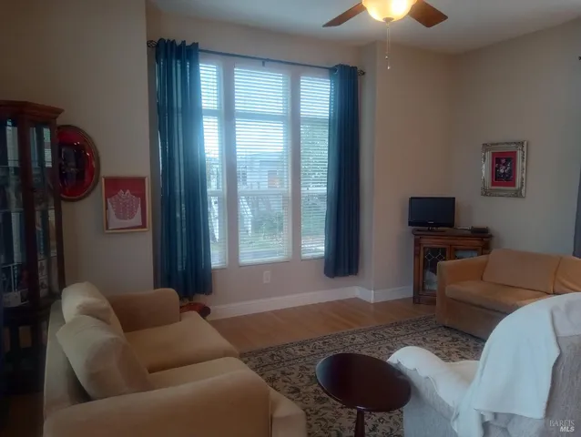a kitchen with kitchen island granite countertop a sink cabinets and wooden floor