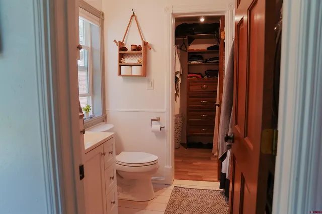 a bathroom with a toilet sink and a mirror