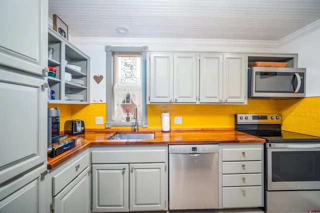 a kitchen with stainless steel appliances granite countertop a sink and cabinets